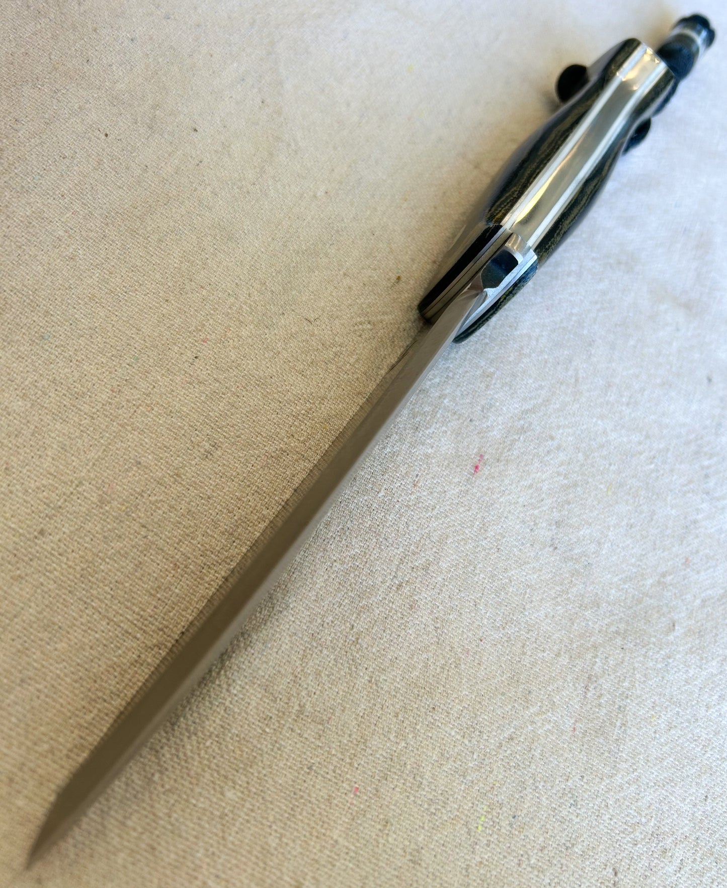 Endure bushcrafter in camo micarta with white G10 and aluminum liners