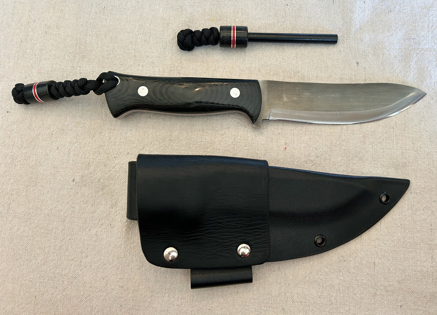 Endure bushcrafter with black canvas micarta with thin red G10 liners