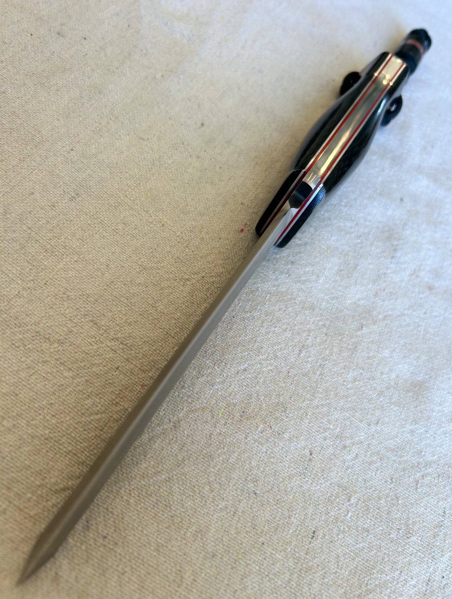 Endure bushcrafter with black canvas micarta with thin red G10 liners