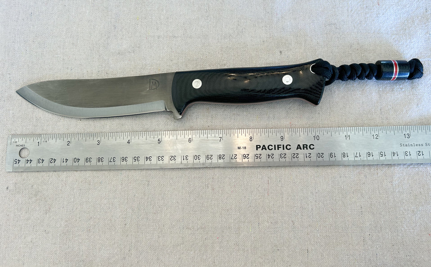 Endure bushcrafter with black canvas micarta with thin red G10 liners