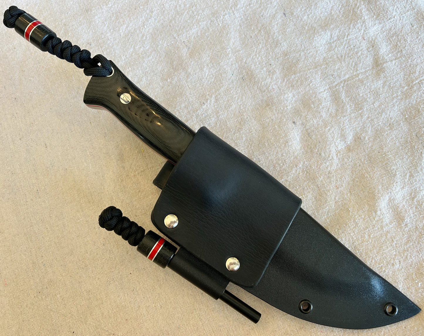Endure bushcrafter with black canvas micarta and Thick red G10 liners