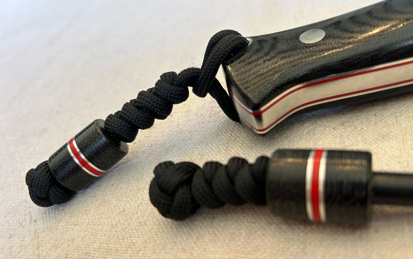 Endure bushcrafter with black canvas micarta with thin red G10 liners